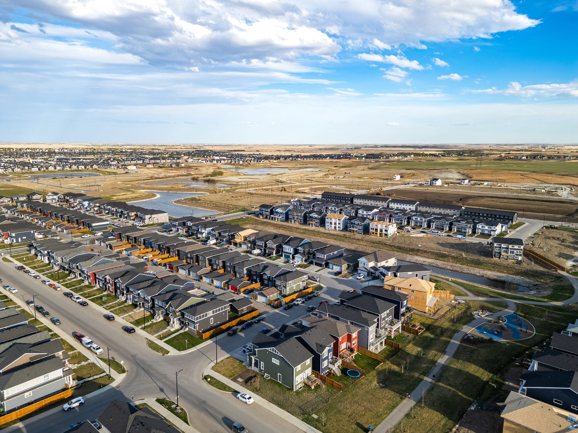 Aerial of South Chelsea in Chestermere showing parks, storm ponds and a future school site.