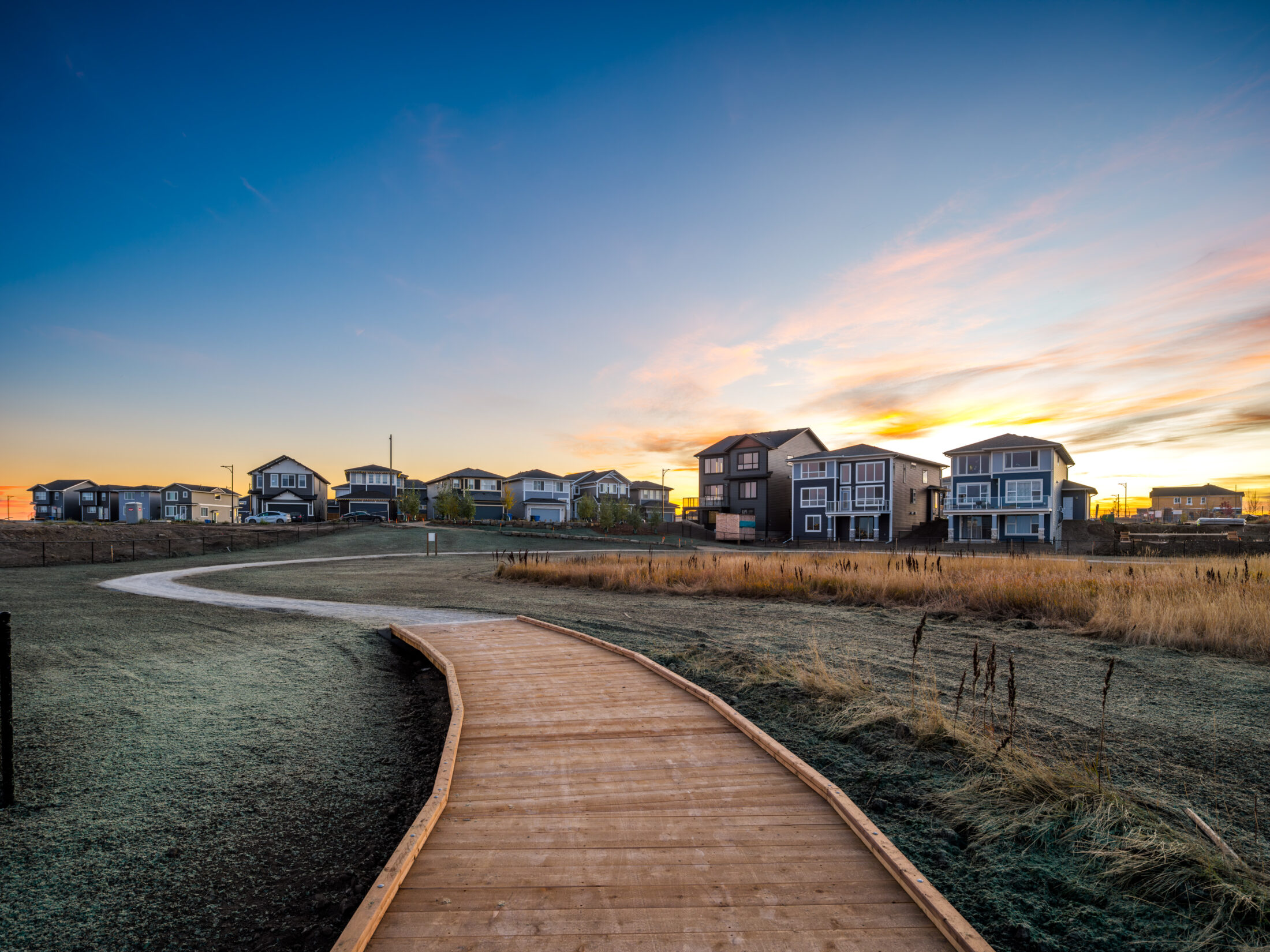 Photo of a boardwalk pathway in a wetland in Chelsea, Chestermere at sunset.